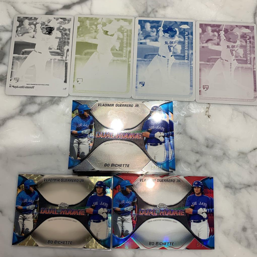 Stacks of Vlad Jr. sports cards in different colors on marble countertop